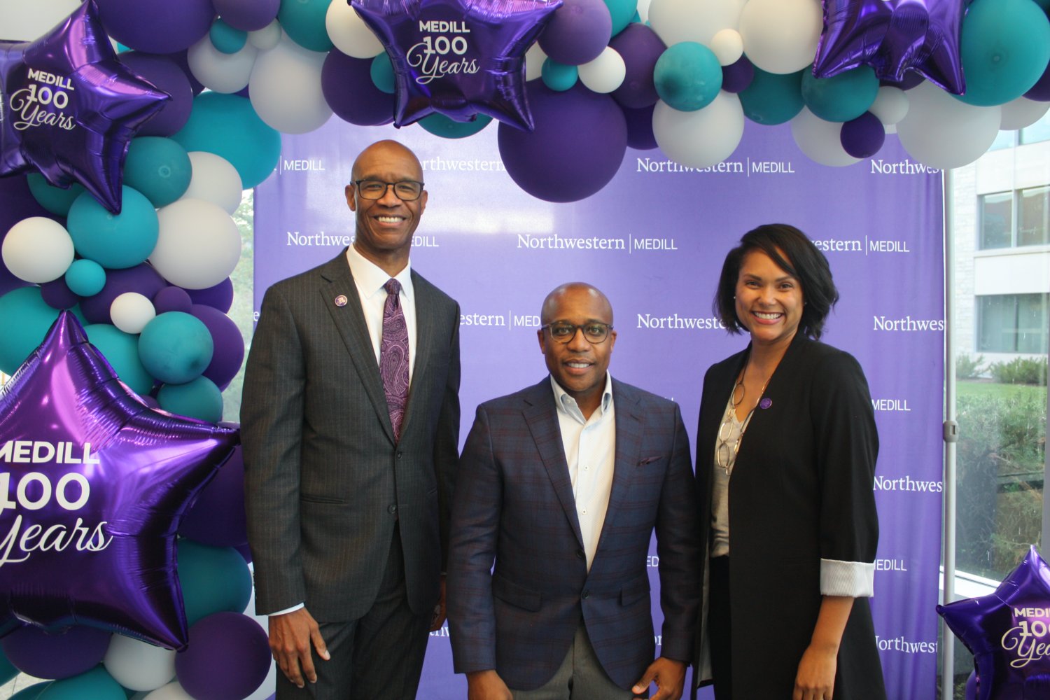 Medill Dean Charles Whitaker, Proctor & Gamble’s CCO Damon Jones, and Danielle Bell, an assistant professor at Medill, pose at a step-and-repeat. Jones was a guest speaker at Medill’s Centennial speaker series, and Bell led the discussion.
